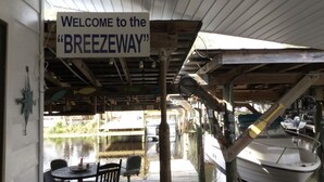 A wooden boat with a sign reading "WELCOME to the 'BREEZWAY'".