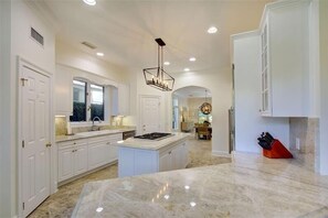 Enjoy cooking in this well-equipped kitchen with a central island and gas stove.