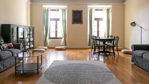 A living room with a sofa, a coffee table, a dining table with chairs, and a cabinet. - Hostel Javni Zavod Mekinjski Samostan (Kamnik)