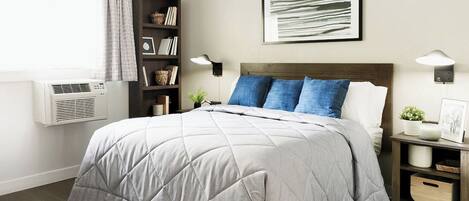 Desk, laptop workspace, bed sheets