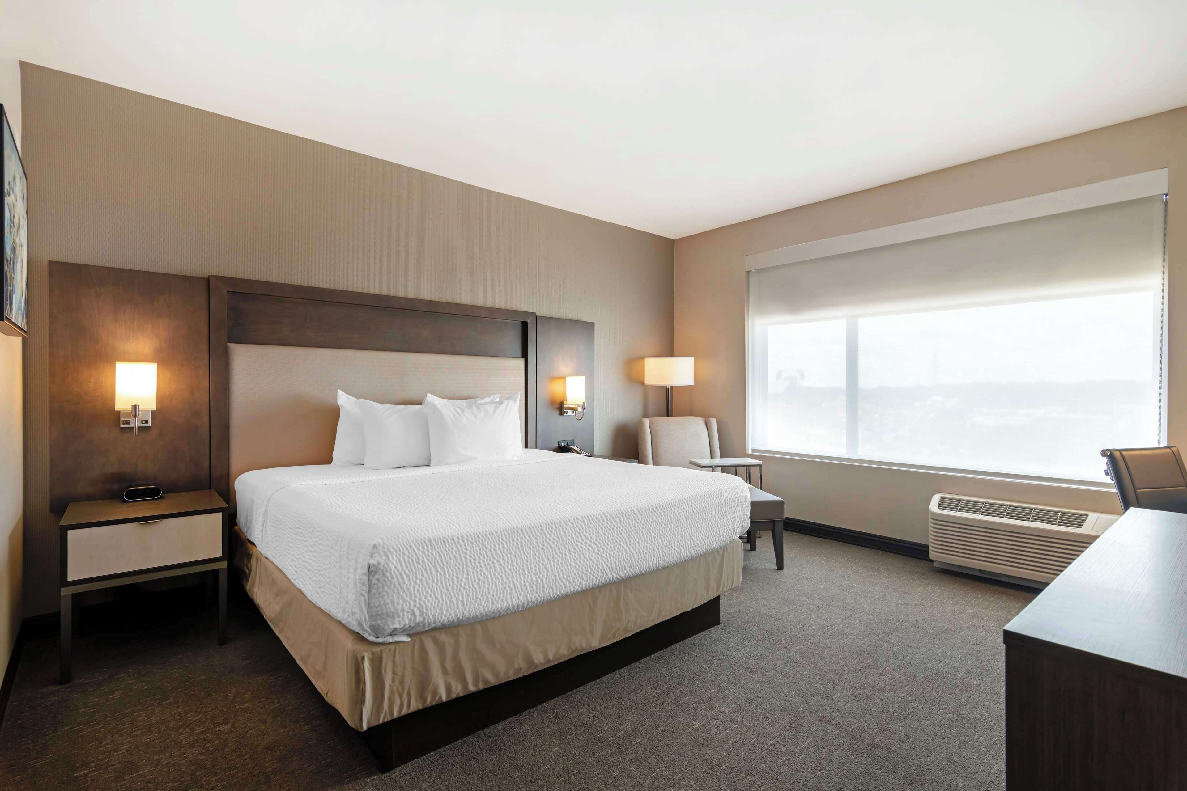 suite, 1 king bed, non smoking, balcony | desk, laptop workspace, iron/ironing board, free wifi