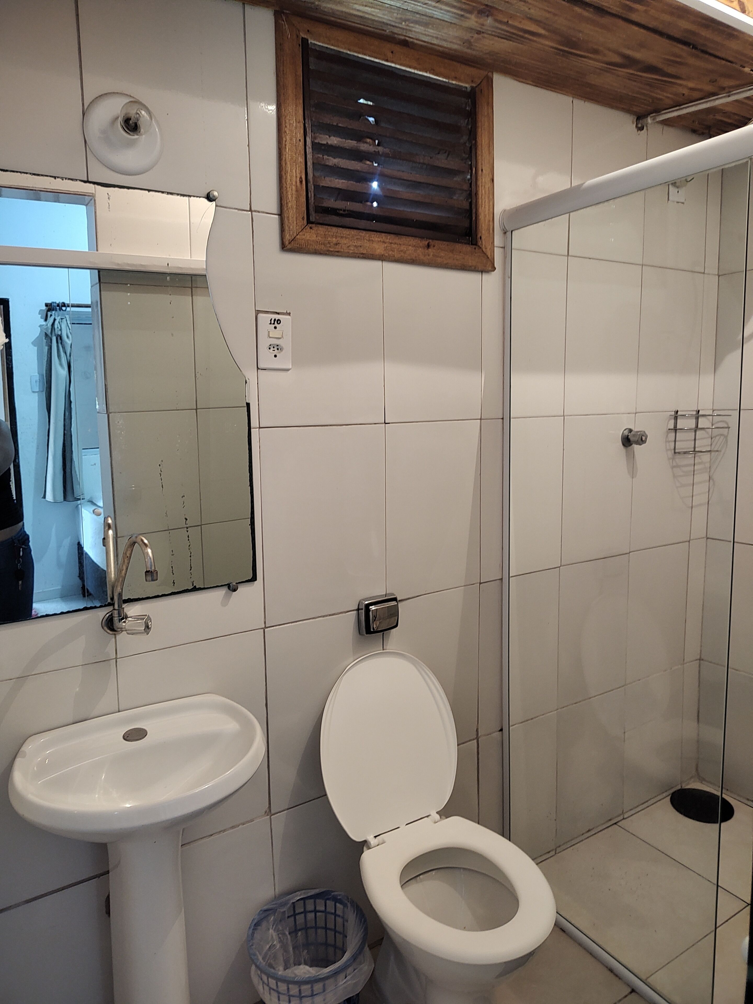 A bathroom with a sink, toilet, and shower.