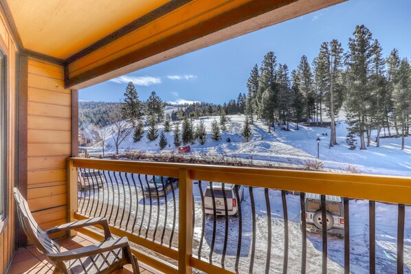 Enjoy breathtaking views of the surrounding landscape from this balcony.