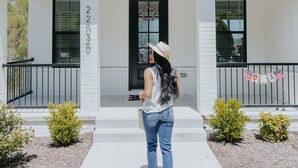 A two-story building with a white facade, black-framed windows, and a black door with a wreath. - The Dogwood - Hot Tub - Lake Front Access (Springdale)