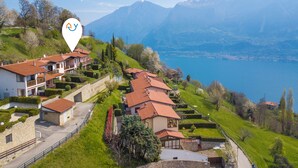 A hillside property with terraced gardens, a lake view, and a mountainous backdrop. - Balcone sul Lago - Apartment with Amazing View Terrace, Tremosine, Italy (Tremosine)
