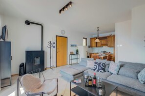 A modern living room with a sofa, coffee table, and a fireplace.