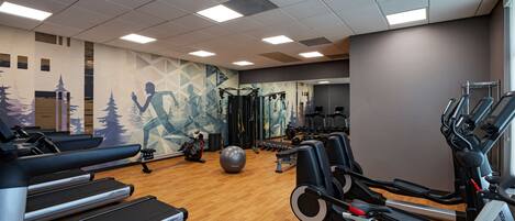 Ett gym med löpband, crosstrainers och styrketräningsutrustning.