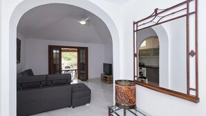 A living room with a sofa, a television, and a decorative lamp. - Summer House, Golf del Sur (San Miguel de Abona, Golf del Sur)