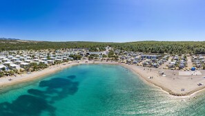 A coastal area with numerous mobile homes and a beach.