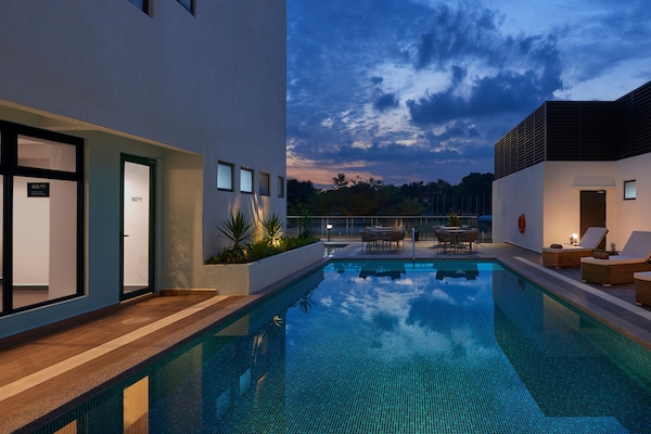 Outdoor pool, open 6:00 AM to 10:00 PM, pool loungers