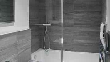 Combined shower/bathtub, towels, soap, toilet paper