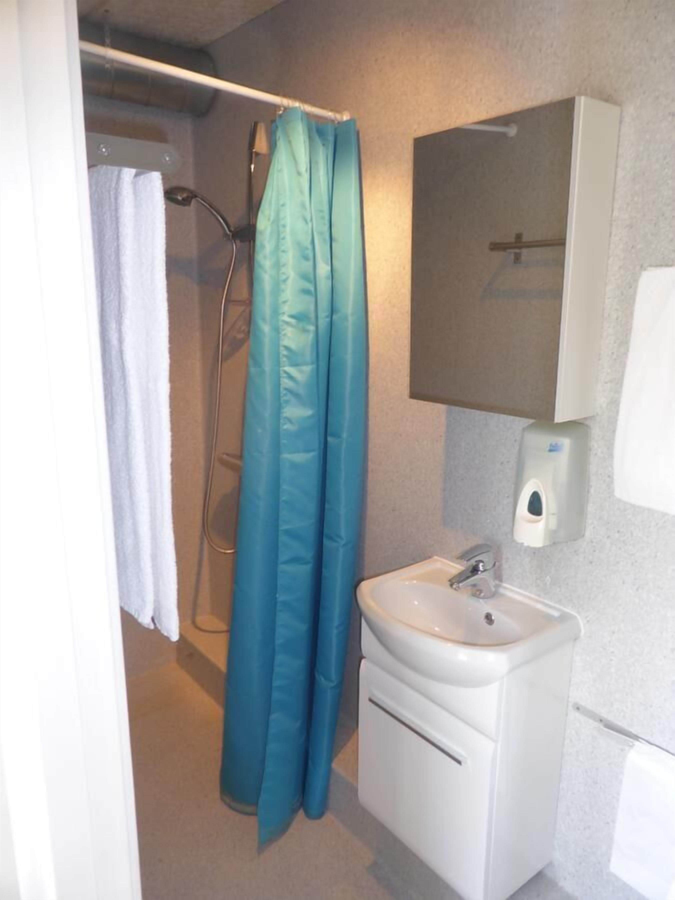 basic twin room | bathroom | shower, hair dryer, towels, soap