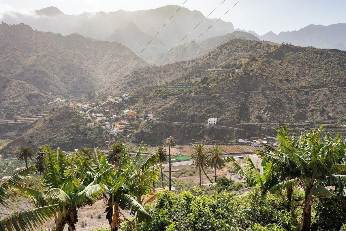 A mountainous landscape with a village nestled in the valley.