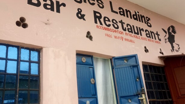 A building with a sign that reads "Eagles Landing Bar & Restaurant" and mentions "accommodation available, rooms with hot showers." - Eagles Lodge (Naivasha)