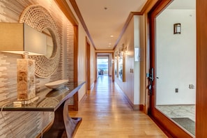  Step through the door into a hallway of warmth and light—where coastal textures, modern art, and ocean views await  