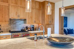 This kitchen glows like a warm croissant—golden, crisp, and ready to be filled with delicious adventures    - The Resort at Kapalua Bay | Ocean View 3 BR | Car Incl. w/ 6+ Nights | MON-6401 by KBM (Lahaina)