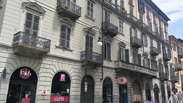 A multi-story building with arched windows and balconies. - Sotto la Mole (Turin)