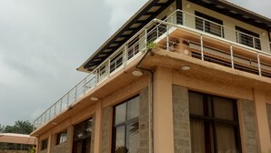 A two-story building with a balcony, large windows, and stone facade. - Matteo's Resort (Naivasha)