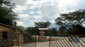 A gated entrance to a property with a sign indicating 'Matthews Italian Restaurant & Bar' and 'Accommodation'. - Matteo's Resort (Naivasha)