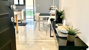 A modern kitchen with a dining area, a large window, and a potted plant. - Impeccable 3-bed Apartment in Athens (Nea Ionia)
