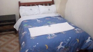 A bedroom with a bed, a bench, and a mosquito net. - The Baron Hotel (Thika)