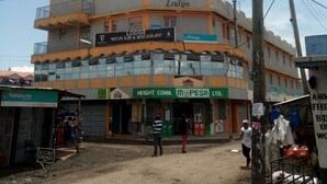 A multi-story building with a sign for 'The Witas Lodge' and 'Guinness Witas Bar & Restaurant'. - Witas Lodge (Nakuru)