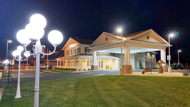A Country Inn hotel with a large, well-lit entrance and a covered parking area. - Country Inn of Hazlet (Hazlet)