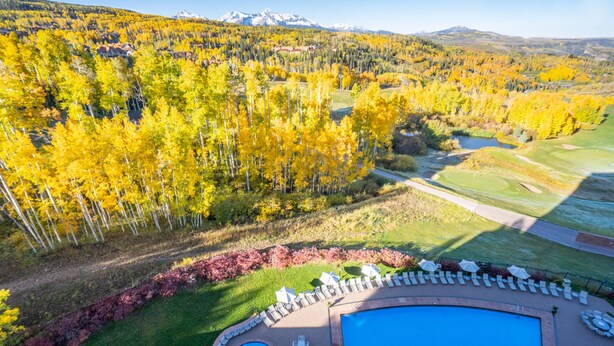 A pool area with a view of a forest and mountains. - 1 bedroom Penthouse at the Peaks Resort and Spa (Mountain Village)