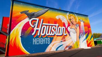 A mural with the text "Houston Heights" and a depiction of a woman in a white dress.