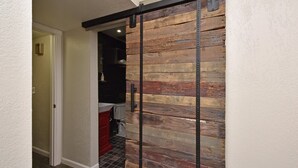 A hallway with a wooden wall and a sliding door. - Desert Escape l 2 Masters l Heated Pool (Mesa)