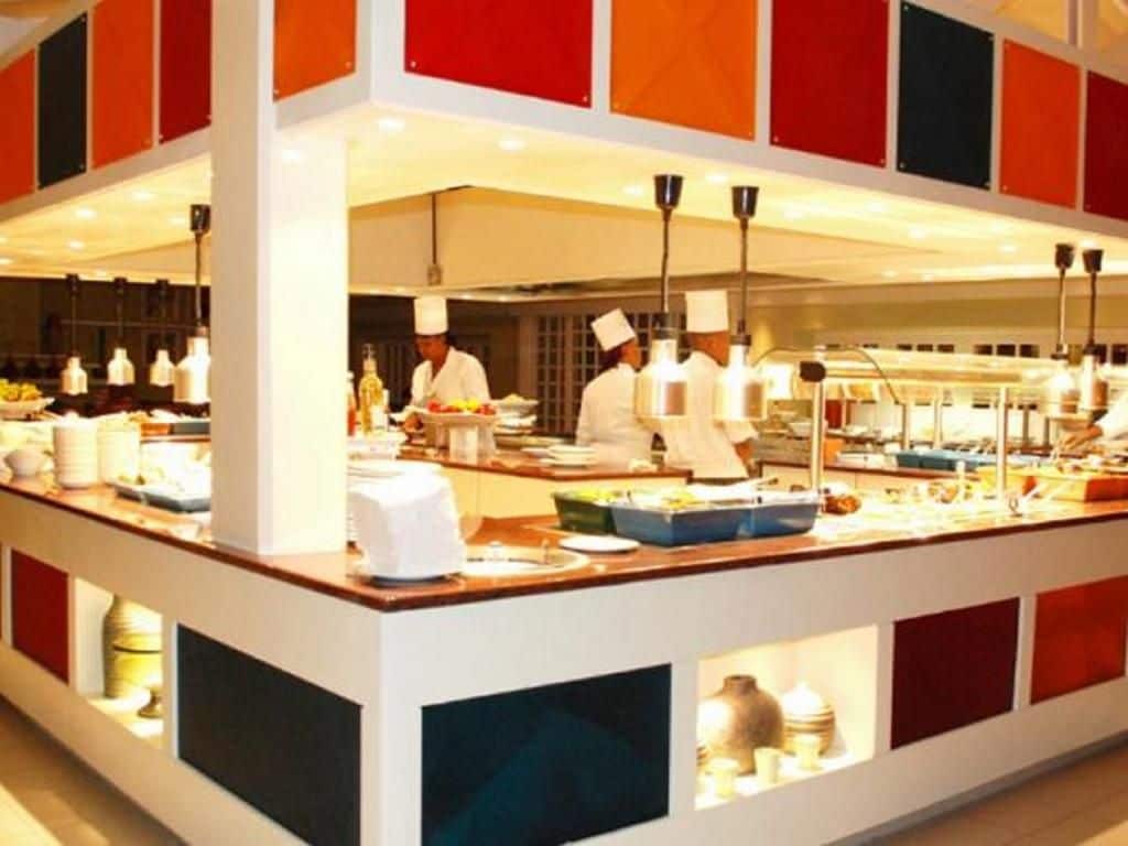 A buffet setup with a central serving area and multiple food stations.