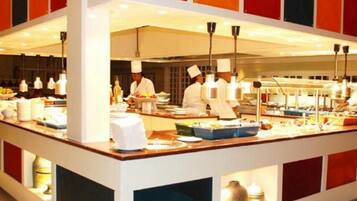 A buffet setup with a central serving area and multiple food stations.