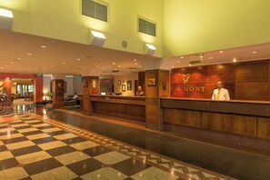 A hotel reception area with a check-in counter, a reception desk, and a check-in counter. - Peermont Walmont Ambassador at the Grand Palm (Gaborone)