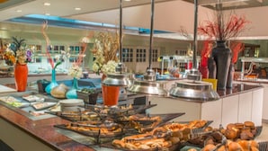 A buffet with various food items and decorative vases. - Peermont Walmont Ambassador at the Grand Palm (Gaborone)