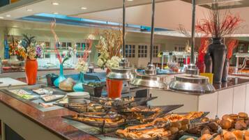 A buffet with various food items and decorative vases.