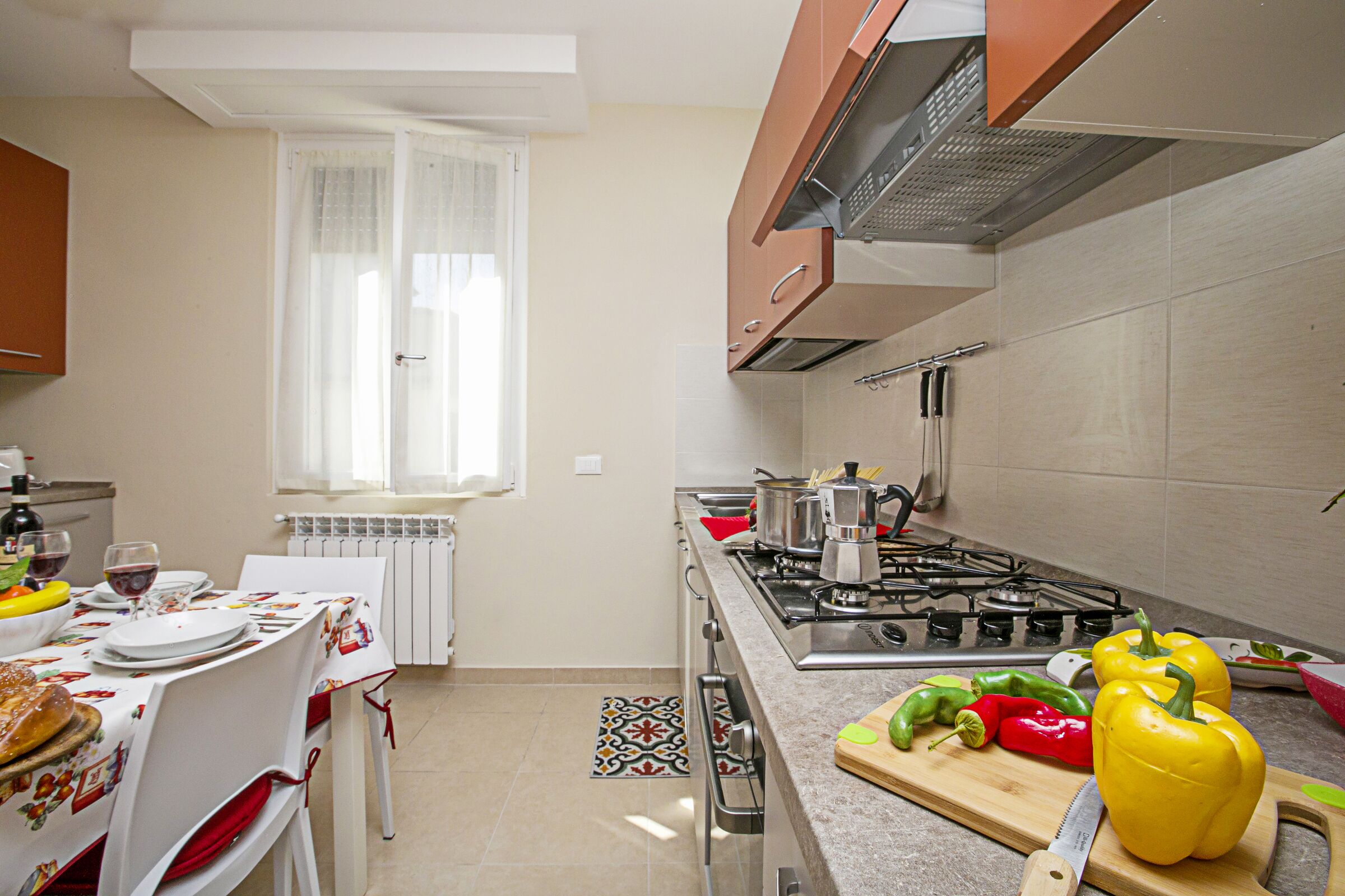 The kitchen counter with cooker hob, oven and dishwasher