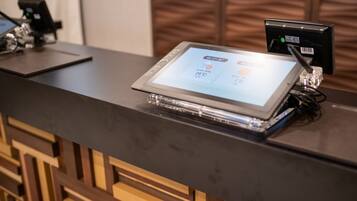 A reception desk with a digital display showing the time and temperature.