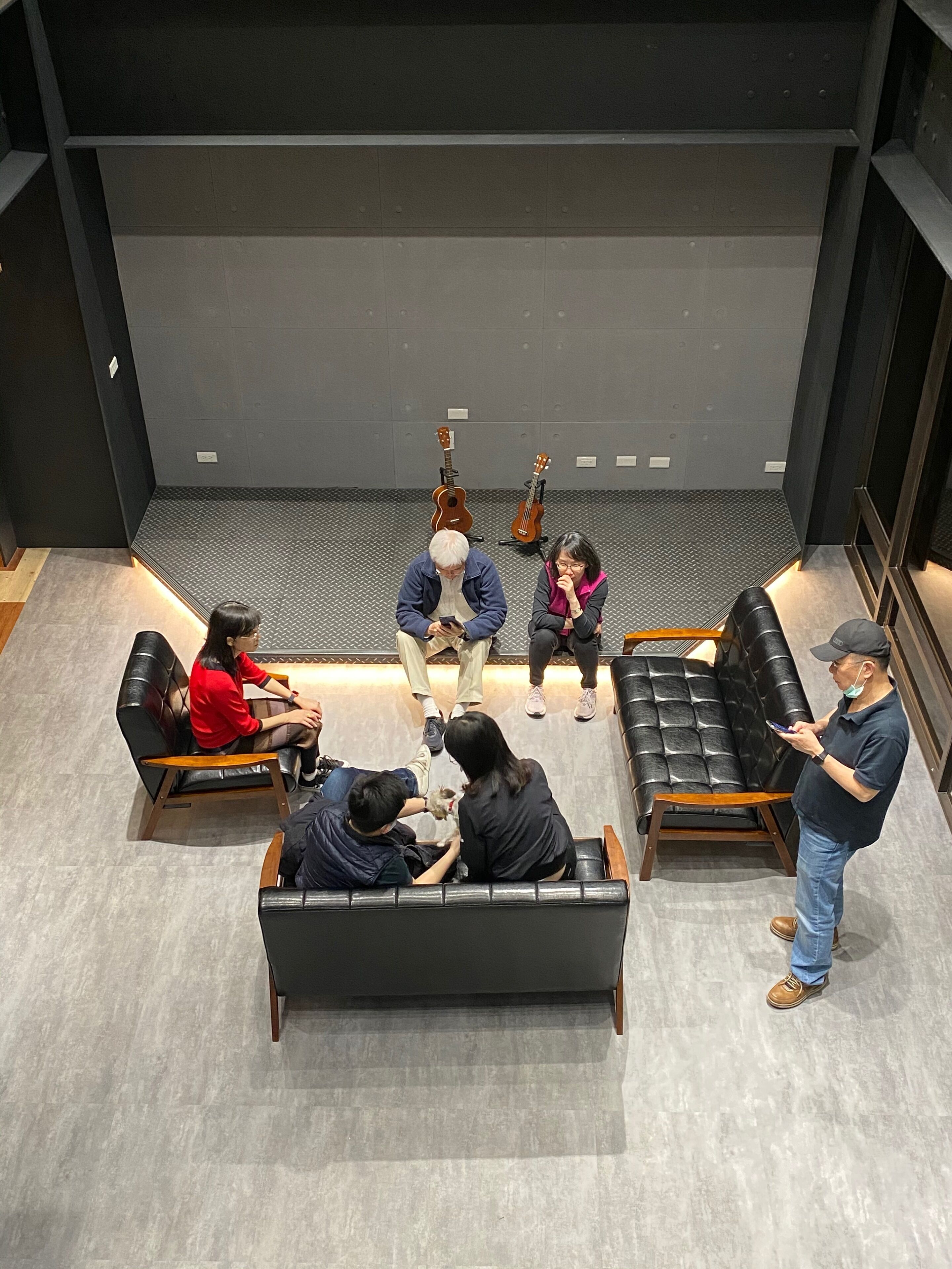 A modern lounge area with leather sofas and a central seating arrangement.