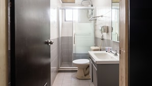 A compact bathroom with a shower, toilet, and sink. - Sipadan Inn 1 (Semporna)