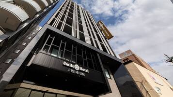 A modern hotel building with a prominent 'Smile Hotel Premium' sign.