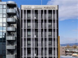 A modern hotel building with a sign reading "Smile Hotel Premium".