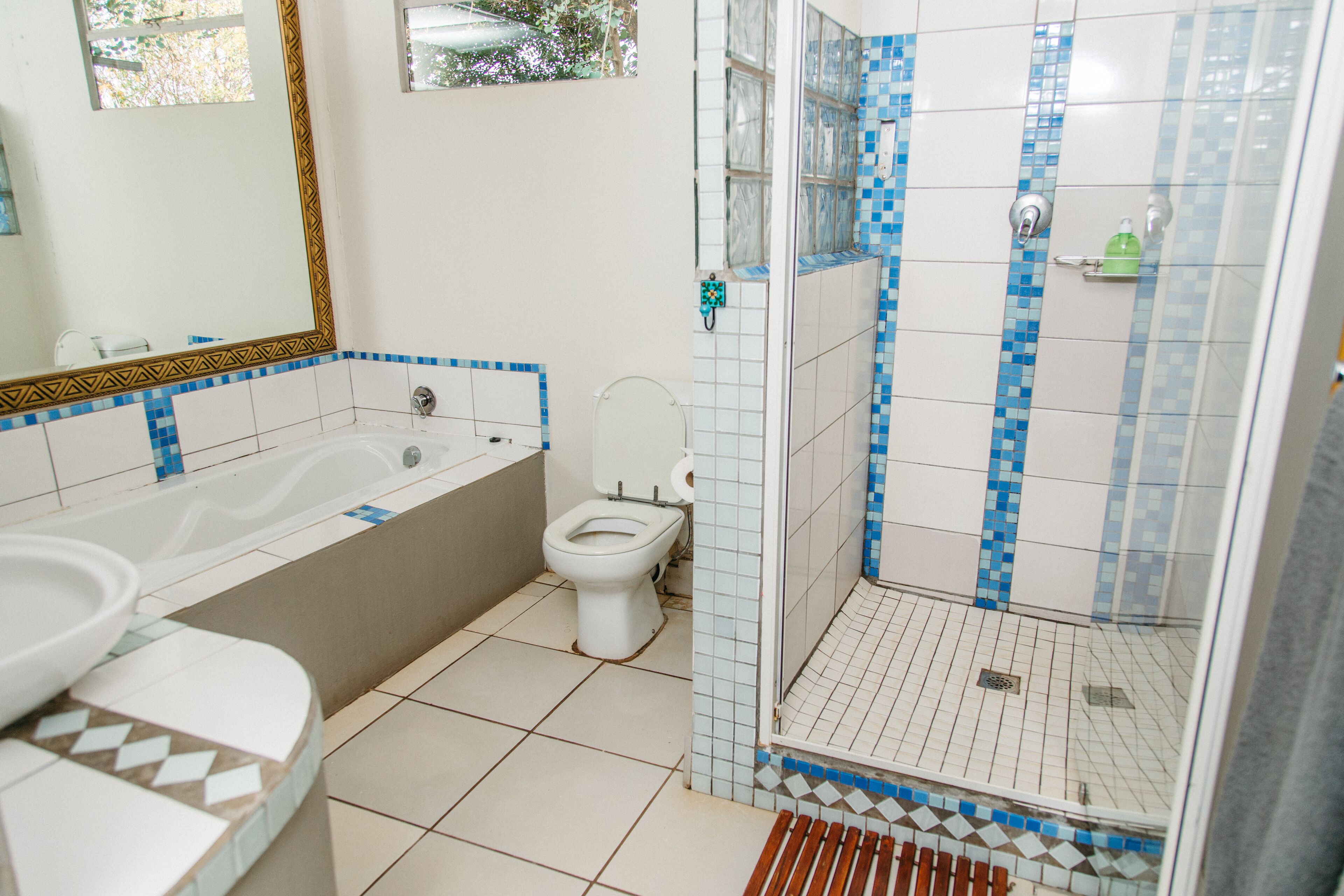 A bathroom with a bathtub, toilet, and shower.