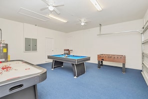 A room with a pool table, a foosball table, and a table tennis table. - South-Facing Pool • Conservation View • Game Room • No Rear Neighbors • Disney (Davenport)
