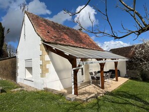 A single-story house with a sloped roof, a covered patio area, and a small garden. - Charming Cottage 6km from La Roche-Posay - Terrace, Garden, Baby Equipment, Pet Friendly, Wifi (La Roche-Posay)