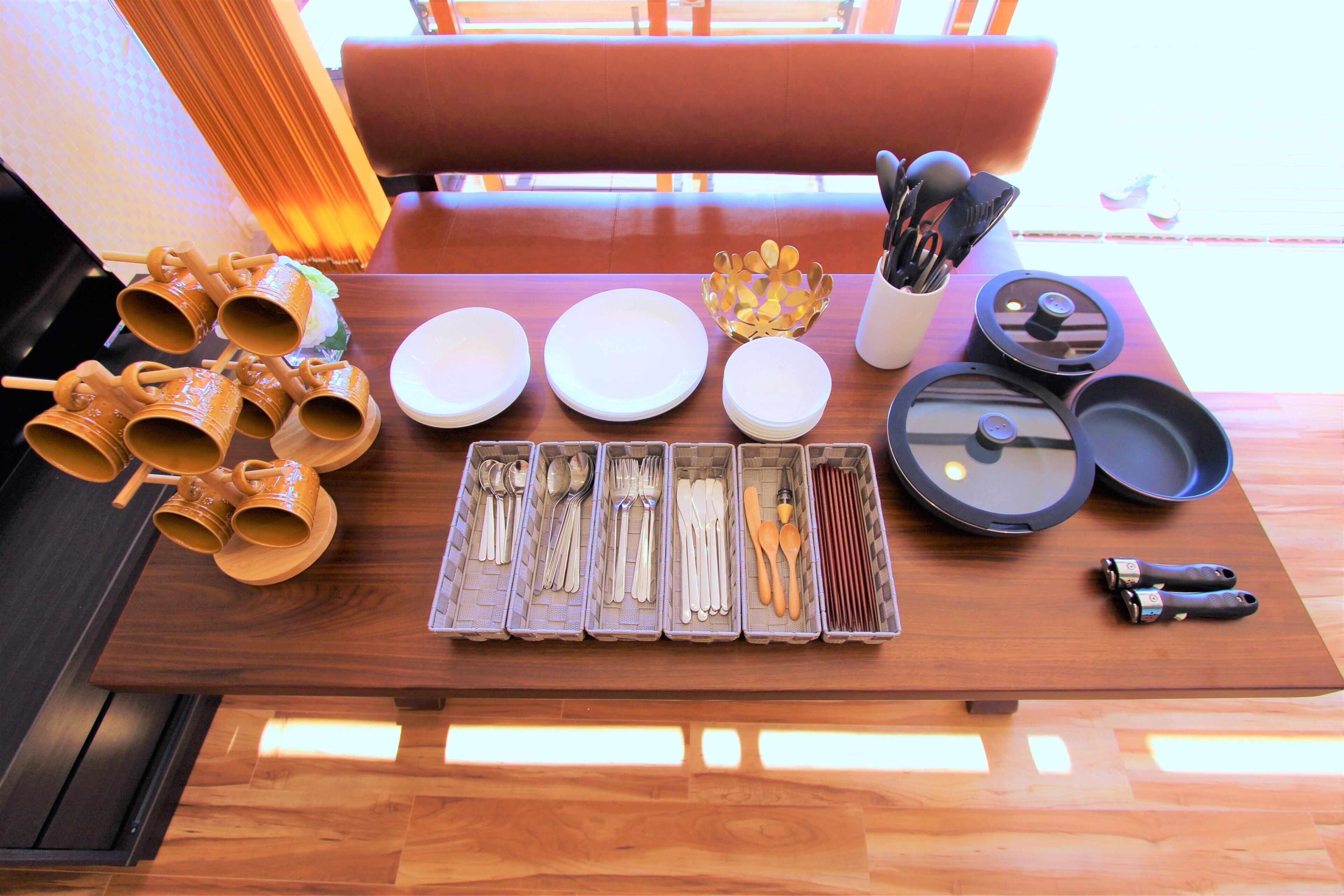 A dining table with various utensils and dishes, a bowl, and a pair of scissors.