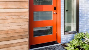 A red door with a glass panel, a mailbox, and a number "1407" on a wooden wall. - Sky Mark Lux 2 - Seattle's Best Modern 3BD HomeTel (Seattle)