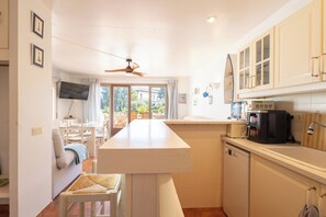 A compact kitchen with a dining area, a ceiling fan, and a view of the outdoors. - Apartment with sea views. Located at 500 m. from the beach. BEGUR-COSTA BRAVA (Begur)