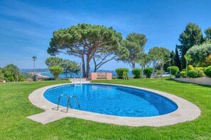 A swimming pool with a clear view of the sea in the background.