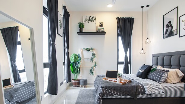 A modern bedroom with a large bed, a bedside table, a mirror, and a window with curtains. - J Dupion Residences at Kuala Lumpur KLCC (Kuala Lumpur)