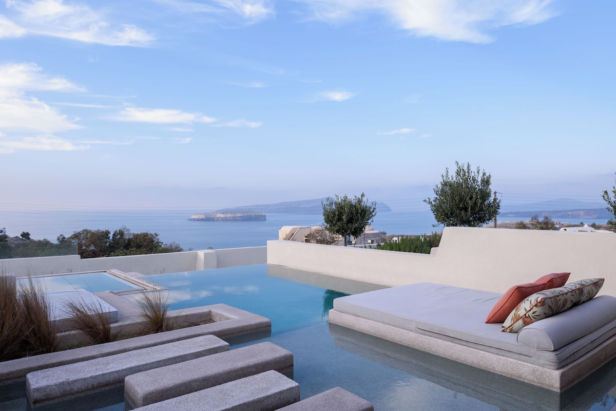 A modern infinity pool with a view of the sea and distant islands.